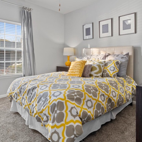 a bedroom with a bed and a fan