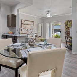 a large dining room with white furniture