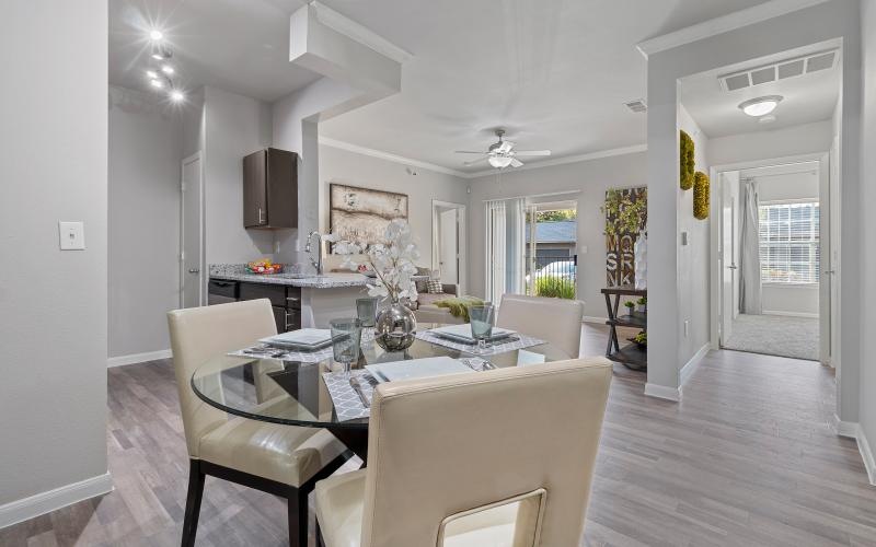 a large dining room with white furniture